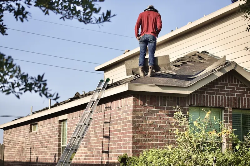 Professional roofer working on a residential roof in Tierra Del Sol